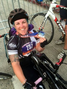 Loma Linda University Health PossAbilities member Jenna Rollman, 28, shows off her first place medal after competing in the 2015 Asics LA Marathon hand cycling race on Sunday, March 15.