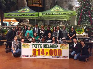 Event volunteers as well as representatives form K-FROG and Stater Bros. Charities proudly display the final total of funds raised for LLUCH during the 14th annual Stater Bros. Charities K-Froggers for Kids Radiothon, Dec. 2