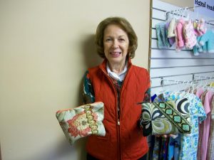 A volunteer for Richland Crisis Pregnancy holds some of our zippered pouches that are so popular with the young mothers.