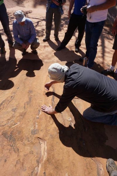 Figure 11. Dr. Gerald Bryant explaining the attitude of the foresets relative to the ground surface (Moccasin Mountain Tracksite, UT).