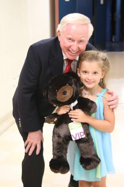 Heritage Singers' Max Mace gives a bear to Brilee Grace. Photo by C. Derry-Bretsch